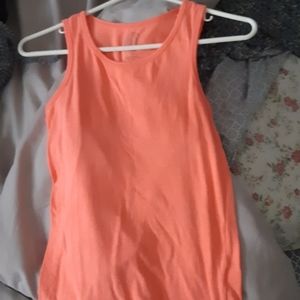 A long bright orange t-shirt. Brand :So